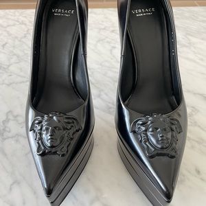 Versace platform point toe stiletto heels. Black leather with Medusa accent.